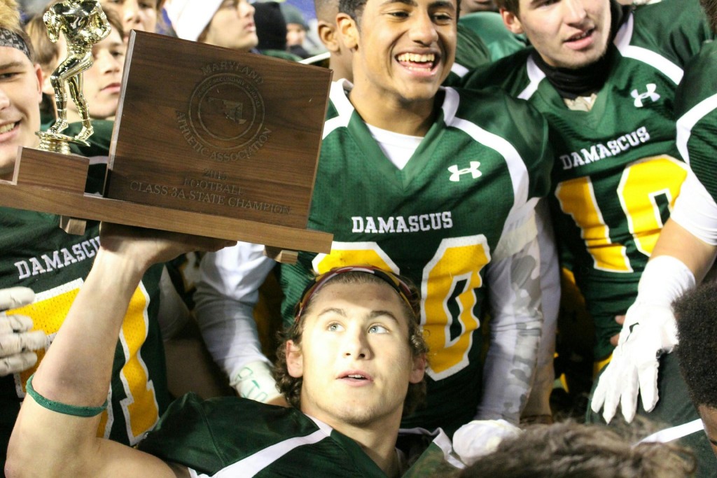 Jake Funk holds the Class 3A state championship plaque moments after Damascus claimed its eighth title in school history. Photo taken by Austin McFadden/Maryland Sports Access.