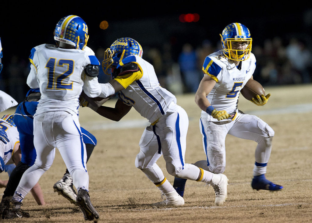 Chad Gleason (right) runs the football in the Class 2A semifinal game against North Caroline. Photo courtesy of The Frederick News-Post.